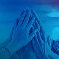 Blue colored image, several hands meet for a group high five