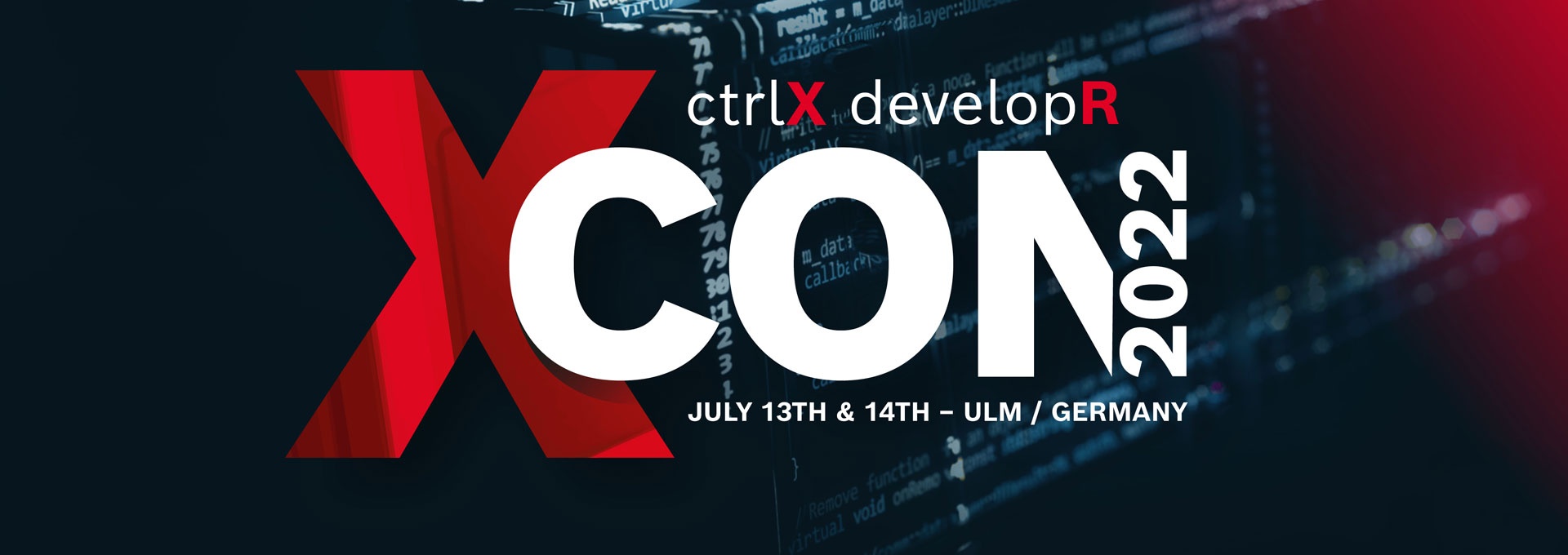 Lettering of the ctrlX developR Confrence (XCON 2022). A ctrlX CORE industrial controller can be seen in the background.