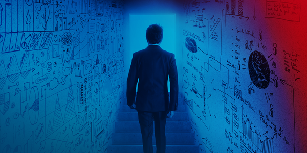 Man walking through a tunnel. The walls are painted with diagrams, formulas and charts.