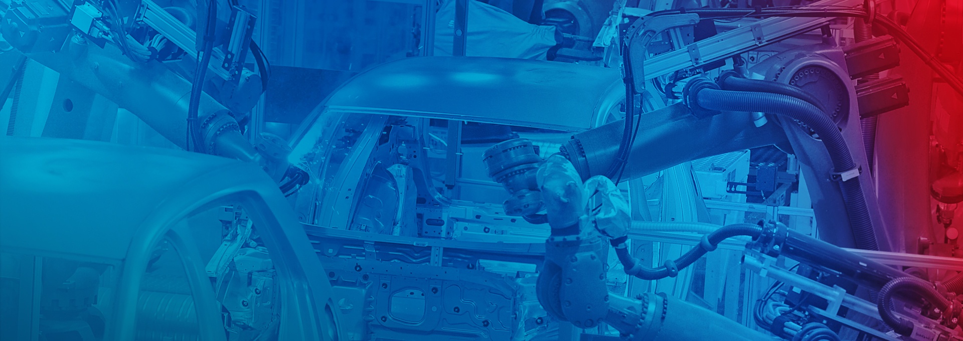 Zautomatyzowana produkcja samochodów: Roboty spawające karoserię samochodu.