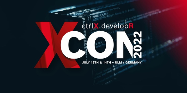 Lettering of the ctrlX developR Confrence (XCON 2022). A ctrlX CORE industrial controller can be seen in the background.
