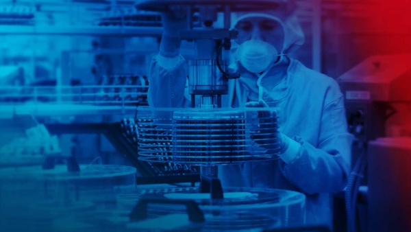 Person handling wafers in semiconductor production