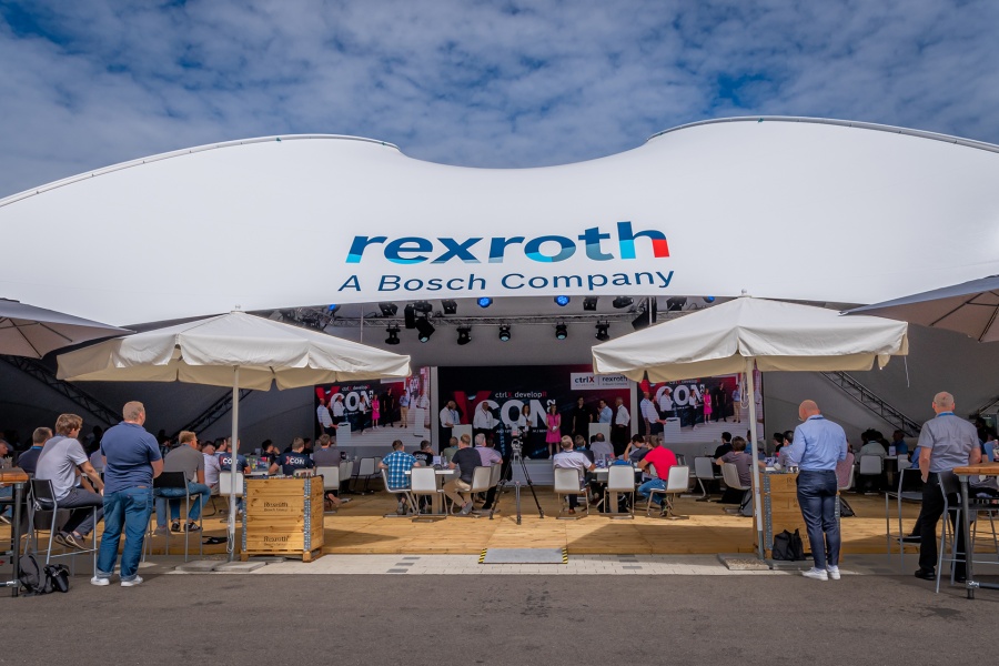 View of the crtrlX developR Conference stage with moderators and speakers