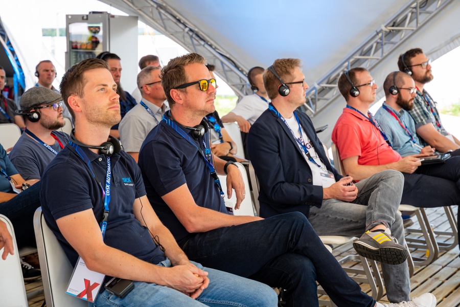 Viewers of the break-out sessions listen to the presentations via headphones